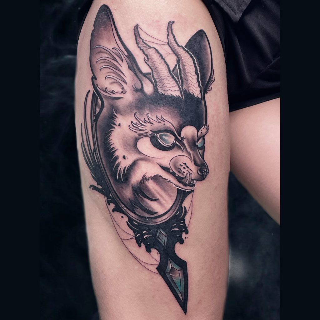 Horned dog tattoo